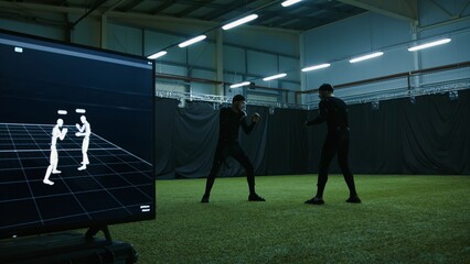 BTS of game industry - Actors in motion capture suits performing some fight moves as a game...