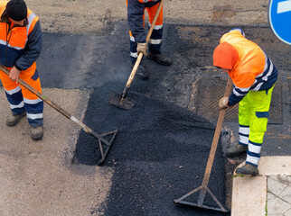 Worker on Asphalting paver machine during Road street repairing works