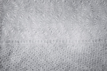 Knitted woolen lace texture background with vignette. Abstract background with copy space for design.