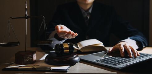 Business and lawyers discussing contract papers with brass scale on desk in office. Law, legal services, advice, justice and law concept picture with film grain effect