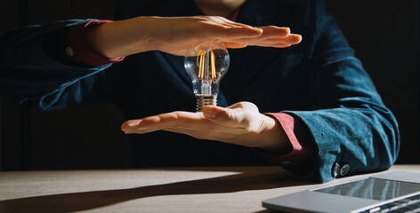 Hand of man holding illuminated light bulb, idea, innovation and inspiration concept.concept creativity with bulbs that shine glitter.