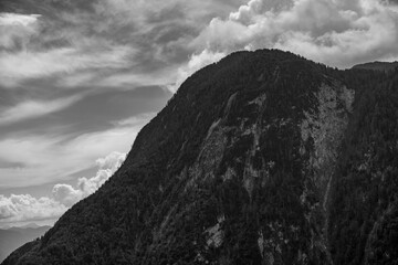 A rugged hill in front of a clouded sky in alps, Sauris, Italy
