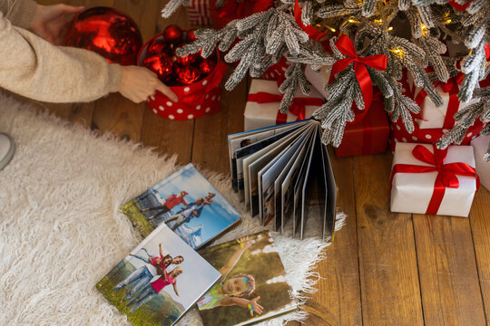 Photo book album under the Christmas tree surrounded by Christmas gifts