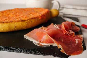 slice of bread with tomato, iberian ham and a cup of coffee typical spanish lunch