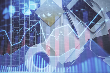 Double exposure of financial chart drawing over table background with computer. Concept of research...