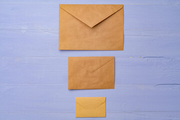 Letter envelope on lavender wooden background, copy space
