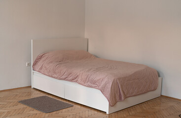 cozy white bed with a pink cover