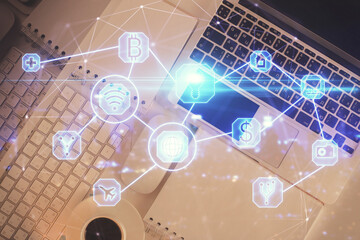 Social network hologram drawings over computer on the desktop background. Top view. Double exposure.
