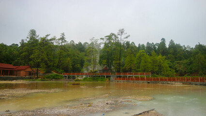 Hot spring lake with green trees