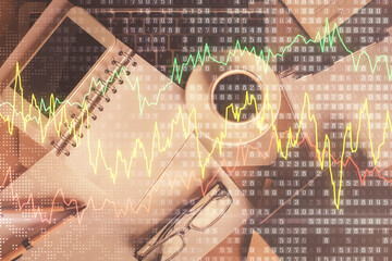 Double exposure of financial graph hologram over desktop with phone. Top view. Mobile trade platform concept.