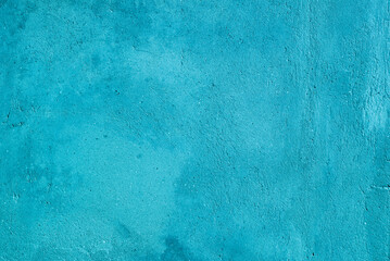 Photo of a turquoise concrete wall aged by time and weather