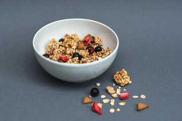 A bowl of muesli on a gray monochrome background, healthy food, healthy breakfast