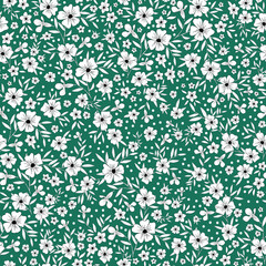 Cute floral pattern. Seamless vector texture. An elegant template for fashionable prints. Print with white flowers and leaves, black outline. green background.