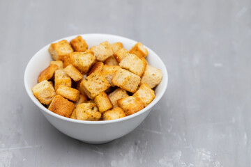Crispy dry cubes of white bread in bowl