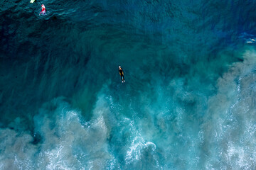 Surfer floating on the blue water surface. Newport Beach, California.