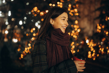 Happy woman at the Christmas market at night