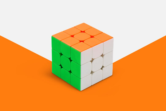 Tri-colored Rubik's cube against a vector background