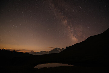 starry night over a mountain lake near Elbrus, milky way