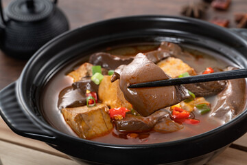 Spicy duck blood jelly soup and stinky tofu with scallion and chili pepper topping.