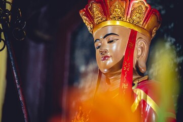 Closeup shot of a Buddhist idol decoration at an alter of a temple in Vietnam