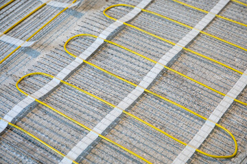 Electric warm floor laying. Cable and fiberglass mesh