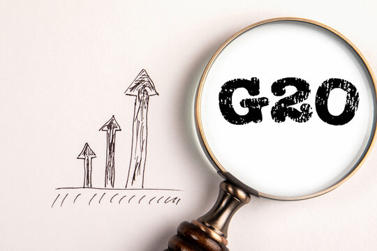 G20. Politics, economics and the concept of cooperation. Magnifying glass on a white background