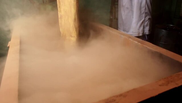 A man pouring mixtures in incense cone making machine