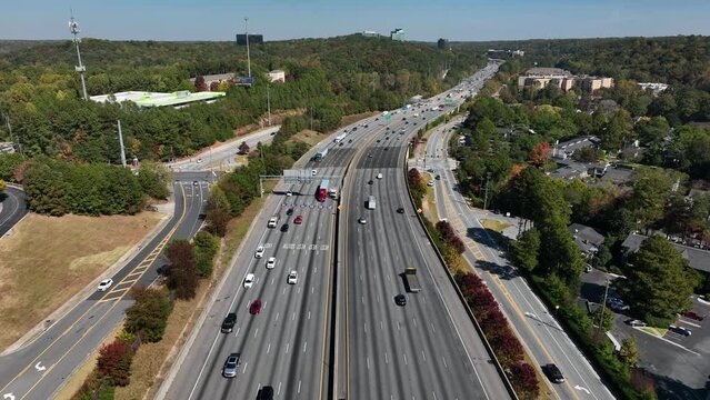 Commuter traffic in urban USA city. Aerial reverse above interstate highway freeway. American transportation and travel theme.