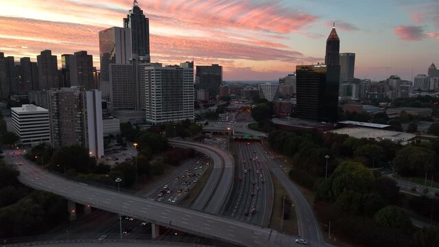 Silhouette of Atlanta Georgia skyline. Colorful sunset with traffic on interstate highway.