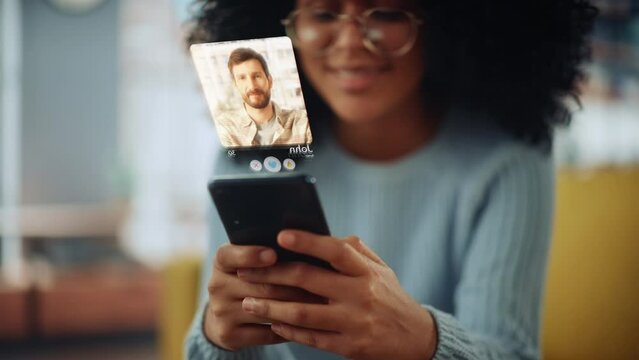 Augmented Reality Dating Concept: Beautiful Black Girl Uses Smartphone for Browsing Social Media Dating App. Lovely Young Brazilian Woman Swiping, Searching, Matching with Partner, Finding True Love
