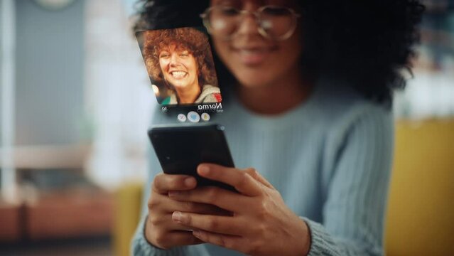 Augmented Reality Dating Concept: Beautiful Black Girl Uses Smartphone for Browsing Social Media Dating App. Lovely Young Brazilian Woman Searching for True Love with the Help of AI Powered Software