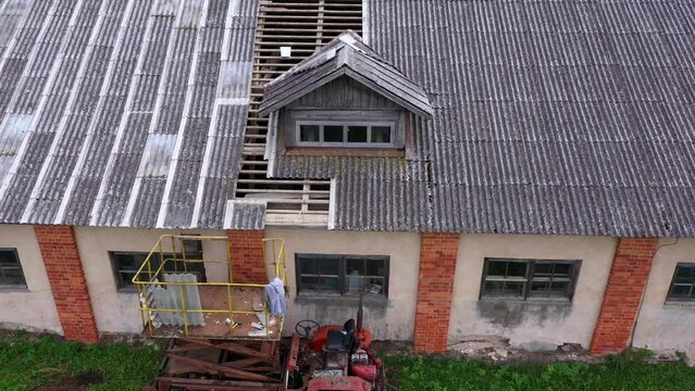 Scissor lift to replace asbestos roof on barn warehouse renovation, farm aerial