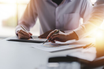 Group of business people meeting to analyze data and brainstorm business plan ideas at office