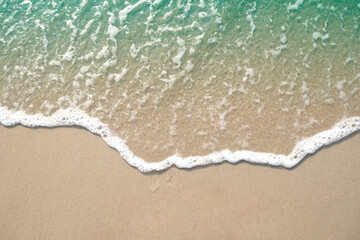 Fototapeta na wymiar Wave of blue ocean on sandy beach. Background