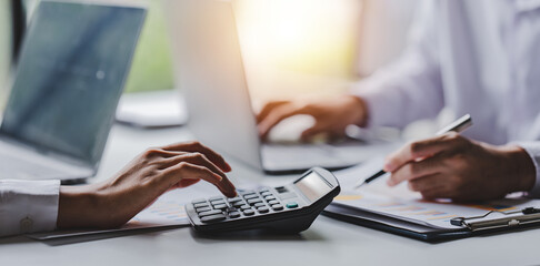 Portrait of a woman working on a tablet computer in a modern office. Make an account analysis...