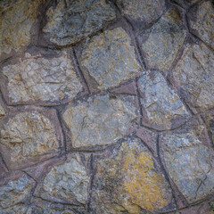 A surface of irregular pieces of stone in various sizes. Rough natural background.