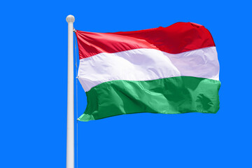 Hungary flag waving against clean blue sky, close up. Hungary flag in the blue sky. Flag Hungary on blue sky background