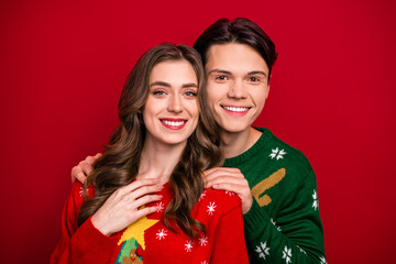 Photo of joyful couple sister brother wife husband have fun good mood enjoy winter holiday event day isolated on red color background
