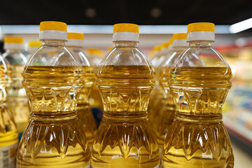 Yellow oil bottles (Soybean oil, Sunflower oil) selling on shelf at supermarket. - obrazy, fototapety, plakaty