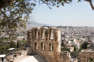 Ancient Greek ruins in Athens, Greece, Europe. Odeon of Herodes Atticus overlooking city. This stone theater is famous landmark of Athens. Old monument close-up, remains of classical Athens.