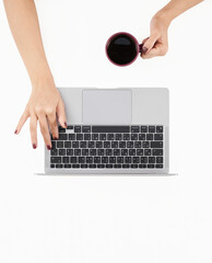 Woman using laptop at clean white office desk with coffee. Top View Stock Photo