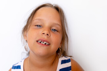 Carefree, calm, confident little blonde girl showing baby temporary milk teeth. Toothless mouth...