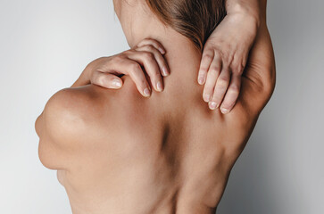 Woman holds neck muscles. Feels pain. Treatment of neuralgia.