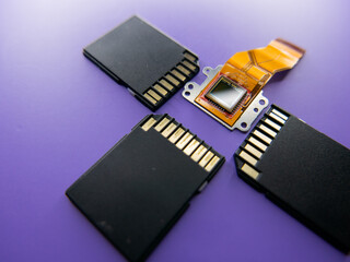 Camera matrix with memory cards on a purple background close-up