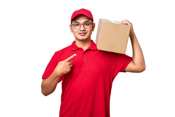 Friendly asian courier wearing red shirt and cap holding box on shoulder and pointing at package