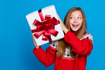 Photo of overjoyed pretty lady hold gift look package guess what inside rejoice xmas time discount...