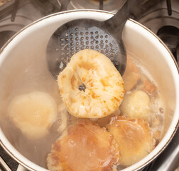 Mushrooms are boiled in a saucepan.