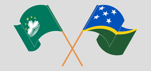 Crossed and waving flags of Macau and Solomon Islands