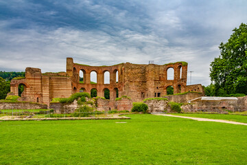 Lovely panoramic view of the Roman bath complex with the Palaestra in the archaeological park of the famous Trier Imperial Baths (Kaiserthermen) in Trier, Germany, on a cloudy day. - obrazy, fototapety, plakaty
