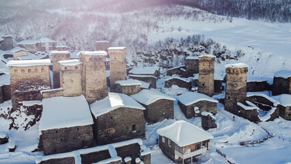 Svan towers in Ushguli view from above, bird view of ancient buildings in the snow, Svaneti, Georgia
